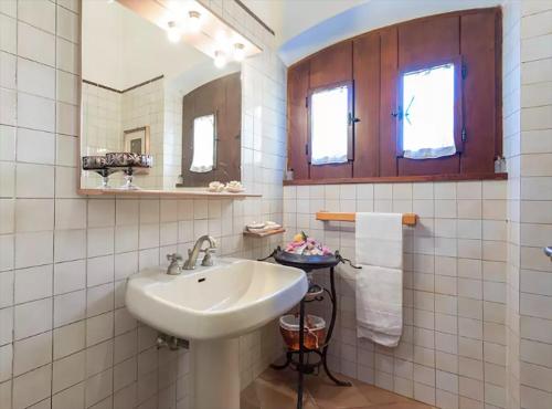 a white bathroom with a sink and a mirror at Private pool Villa Wine&cooking -Trasimeno Lake in Panicale