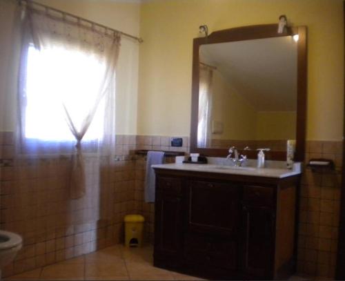 a bathroom with a sink and a mirror at L' Alba di Alice in Silvi Marina