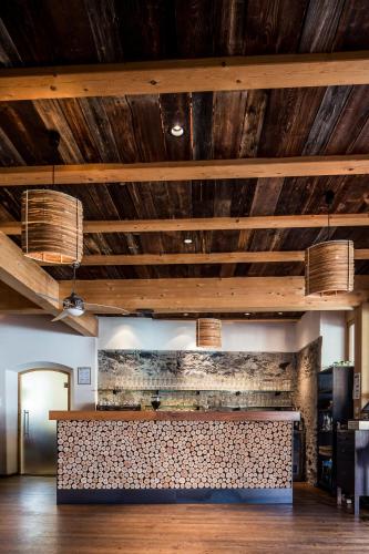 a bar in a room with wooden ceilings at Kircherhof in Bressanone