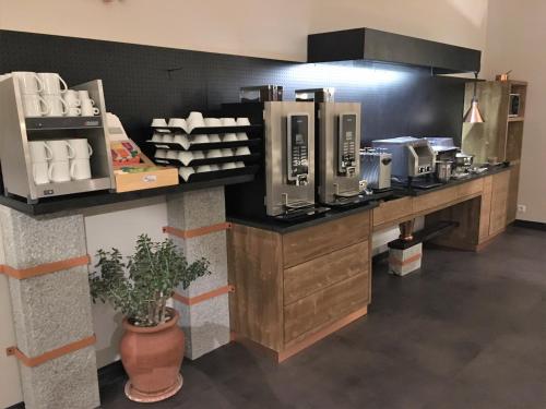 a kitchen with a counter with aasteryasteryasteryasteryasteryasteryasteryasteryastery at Hotel de la Jamagne & Spa in Gérardmer