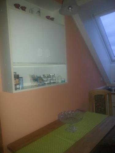 a room with a green table and a window at "Heiterer Blick" in Annaberg-Buchholz