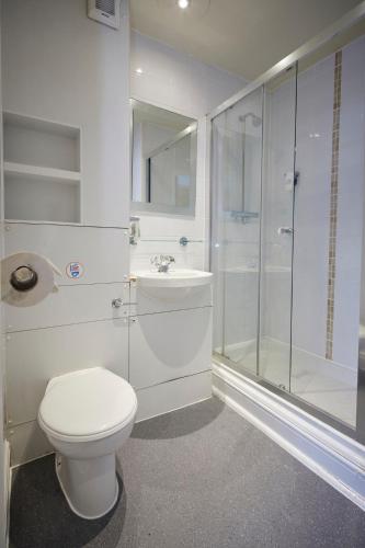 a bathroom with a toilet and a shower and a sink at Childwall Abbey, Liverpool by Marston's Inns in Liverpool