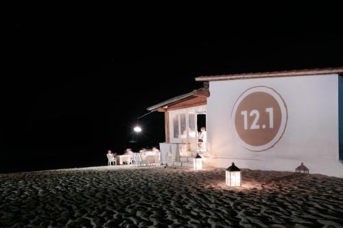 a group of people sitting outside of a building at night at Molarotto in Porto Taverna