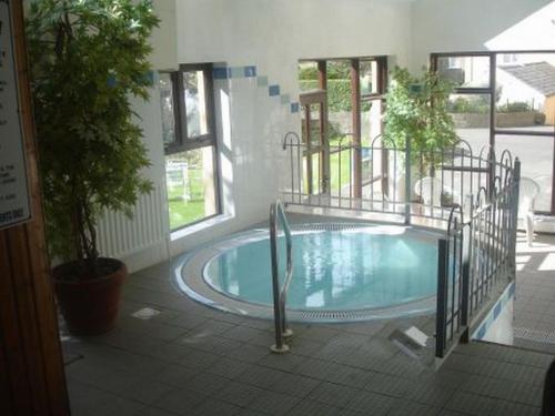 a large swimming pool in a building with at Atlantic Apartotel in Bundoran