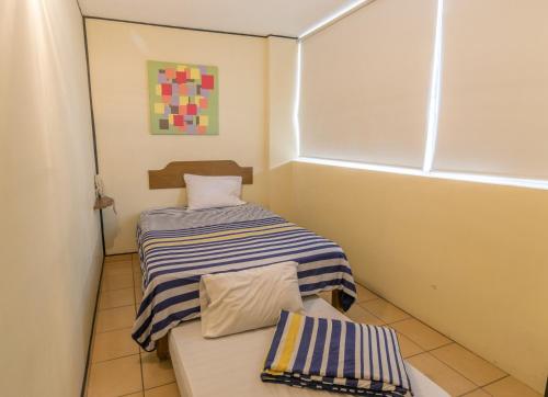 Tempat tidur dalam kamar di Hotel Mateos 1215