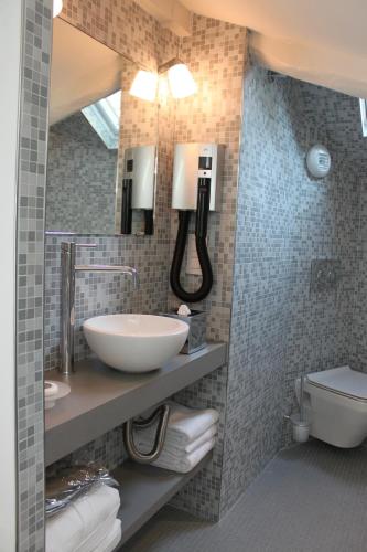 a bathroom with a sink and a toilet at My Home In Paris in Paris