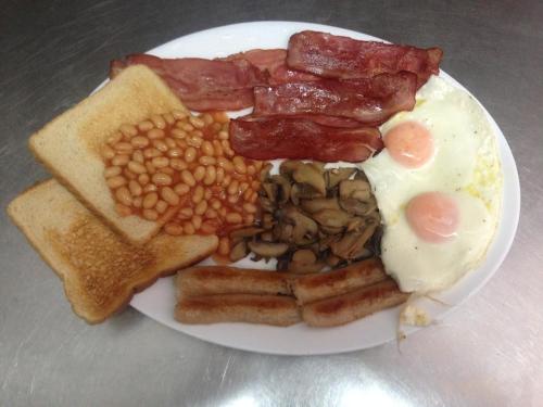 een bord ontbijtproducten met eieren spekbonen en toast bij Captains Studios & Apartments in Kavos