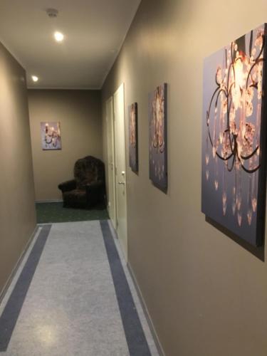 a hallway with paintings on the walls at Rocca Apartments in Tallinn