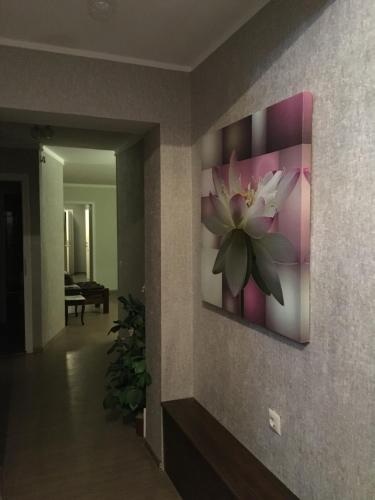a painting of a flower on a wall at Rocca Apartments in Tallinn