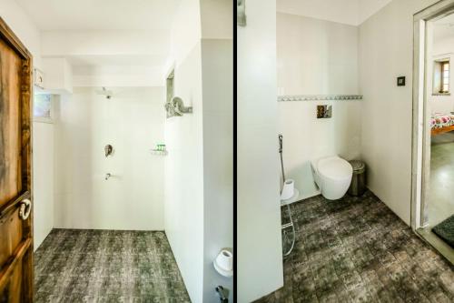a bathroom with a toilet and a sink at The Neem Tree in Udaipur