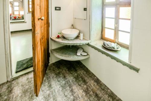 a bathroom with a sink and a mirror at The Neem Tree in Udaipur