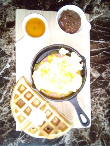 a pan with food at The Red Hut Inn in Belize City
