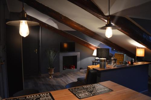 a living room with two lights and a table at Viola Home in Turin