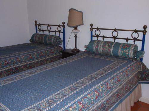 two beds sitting next to each other in a room at Quinta da Serrana in Ourém