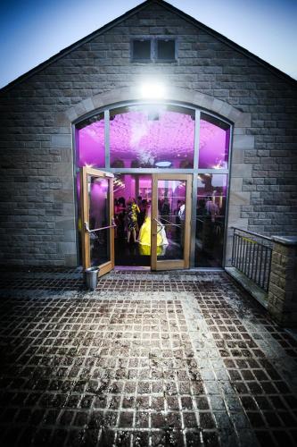 a building with a door open with people standing inside at The Saddleworth Hotel in Diggle