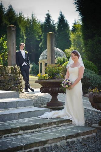 a woman in a wedding dress standing on some steps at The Saddleworth Hotel in Diggle