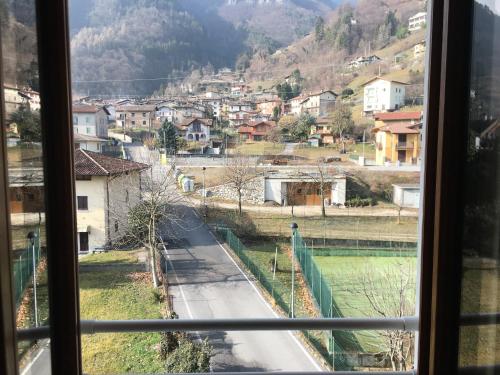 a view of a city from a window at Albergo al lago in Anfo