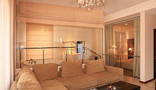 a living room with a couch and a bedroom at Uliss in Odesa