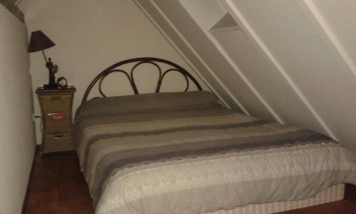a bedroom with a bed in a stair room at Romantic Studio Vacances in Labaroche