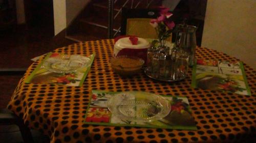 a table with a black and white polka dot table cloth at Takashi Homestay North Paravur Near Muziris in North Paravur