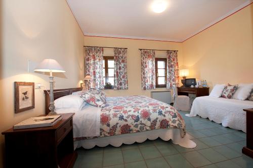 a bedroom with a bed and a table and a couch at Hotel Molino D'Era in Volterra