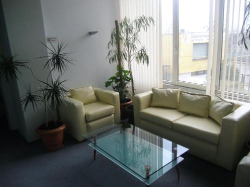 a living room with two chairs and a glass table at Uliss in Odesa