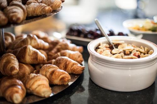 a bunch of pastries and croissants on a table at Hotel La Baia in Diano Marina