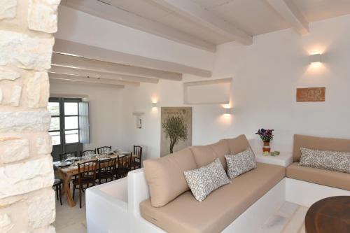 a living room with a couch and a dining room at Sea Swell Villas at Santa Maria in Santa Maria