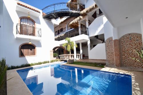 a view of the exterior of a building with a swimming pool at Villas Amalia Hotel in Sayulita