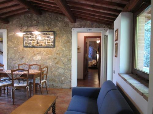 a living room with a table and a blue couch at Casale Eredità in Orte