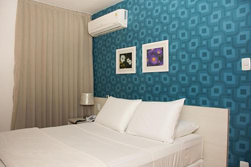 מיטה או מיטות בחדר ב-Unico Apart Hotel
