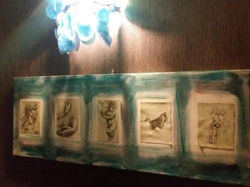 a picture frame with pictures of cats on a wall at Anna Vì Guest Home in Rome
