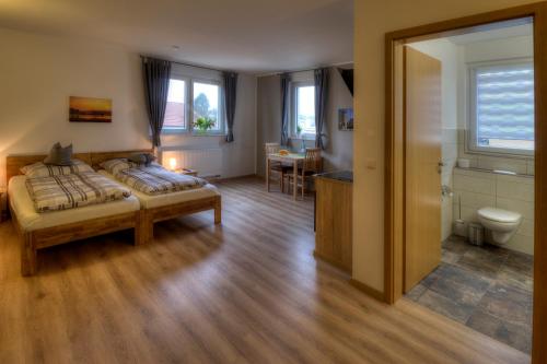 a bedroom with two beds and a bathroom at Pader-Motel in Paderborn