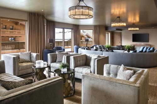 a large living room with couches and chairs at Guarda Golf Hotel & Residences in Crans-Montana