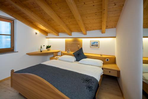 ナトゥルノにあるOberversant Hofの木製の天井が特徴のベッドルーム1室(大型ベッド1台付)
