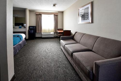 a hotel room with a couch and a bed at City Center Inn and Suites in San Francisco