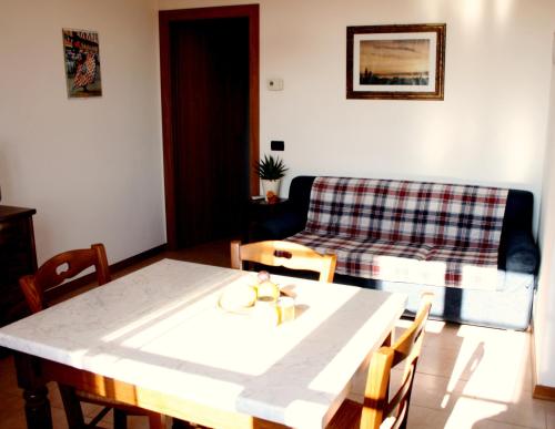 a living room with a table and a couch at Podere Olmo Adriano in Sovicille