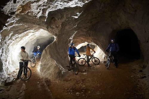 a group of people riding bikes in a cave at Apartmaji Koželj in Ribnica na Pohorju