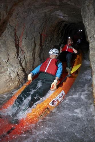 two people in a kayak in a cave at Apartmaji Koželj in Ribnica na Pohorju