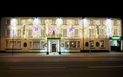 a lit up building with christmas lights on it at The Golden Lion Hotel in Northallerton