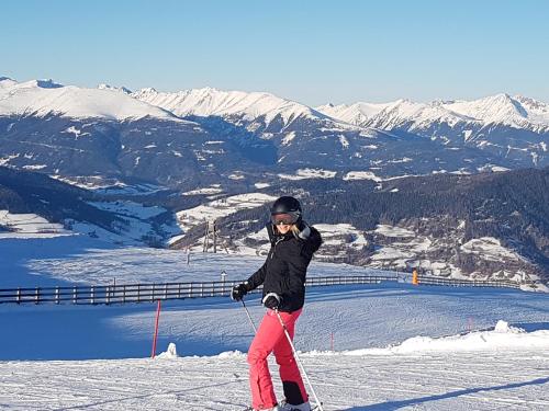 a woman on skis in the snow on a mountain at Haus Speck`n in Ranten