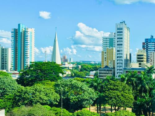 a view of a city skyline with a church tower at Hotel Avalon Maringá Econômico in Maringá