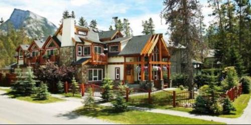 a large house with a fence in front of it at Beaujolais Boutique B&B at Thea's House- Adults Only in Banff