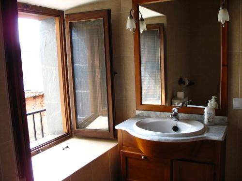 a bathroom with a sink and a window at Brañuelas, Estacion 1 in Brañuelas