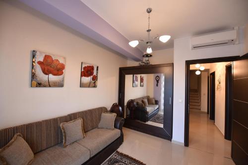 a living room with a couch and a mirror at Artisti Elena in Paralia Katerinis