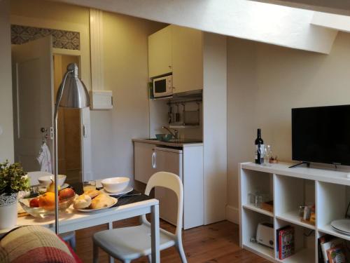a kitchen with a table with a plate of food on it at Ah33 - Estúdios in Coimbra