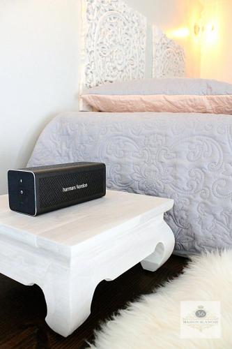 a laptop sitting on a table next to a bed at 'Maison Blanche' in Cannes
