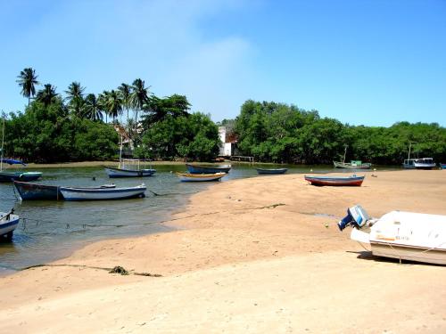 a group of boats sitting on the sand on a beach at Casa na praia de Setiba com panorama fantástico in Guarapari