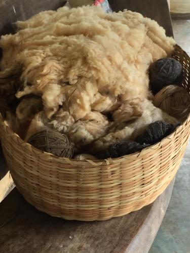 a basket filled with yarn sitting on a table at Delirius Hospedagem in Itamonte
