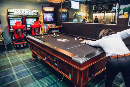 
a man is playing a video game on a table at Hornsby Inn in Hornsby
